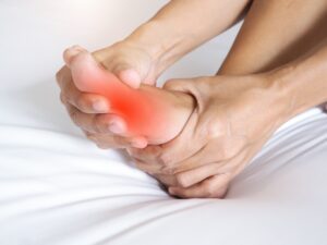 Asian people suffering from severe foot pain. hands reflexology massage pressure points on feet to relieve pain